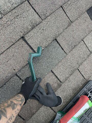 Our Inspector then used a snake tool to safely install the shingles provided by the insurance company.