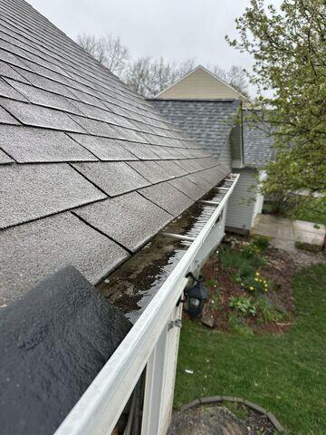 This photo shows the gutters clogged with debris. This photo was also taken upon the initial inspection.