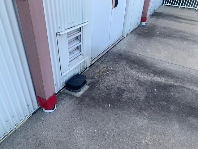 This section was back near the loading dock. There was a slight gap between the siding of the warehouse and the concrete.