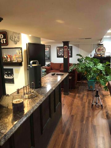 This finished basement had beautiful cabinetry, built-in storage, and finished flooring, but the sinking slab beneath threatened to create cracks, uneven surfaces, and potential damage if left unaddressed.