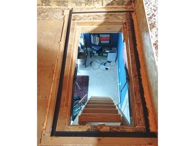 After sealing the attic frame with foam sealant, we added weather stripping to ensure the hatch is airtight.