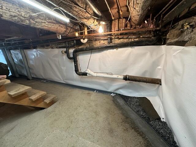 CleanSpace® Wall System: A bright, durable vapor barrier was installed over the interior walls. This system not only improves the appearance of the basement but also directs any seepage into the drainage system while preventing moisture from evaporating into the air.

DryTrack® Drainage System: Installed along the perimeter, DryTrack collects water seeping from the wall-floor joint and channels it directly to the sump pump without clogging or disturbing the footing.