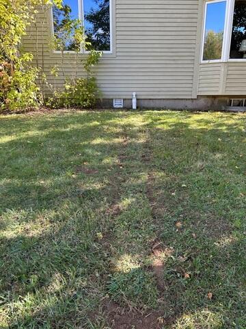 IceGuard® Discharge Line Protection: To prevent frozen discharge lines during Vermont's cold winters, IceGuard fittings were added outside the home. These allow water to escape even if the pipe freezes or becomes blocked safely.

LawnScape® Outlet: The sump pump discharge line was extended to a discreet LawnScape outlet, which releases water away from the foundation without disturbing the yard or landscaping.