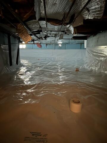 Drainage Matting: Placed beneath the CleanSpace liner, this allows any water beneath the barrier to flow easily toward the SmartDrain for removal. CleanSpace® Encapsulation System: A heavy-duty, 20-mil reinforced vapor barrier was installed over the entire crawl space floor and walls. This durable liner completely seals out moisture from the earth, preventing humidity, odors, and vapor from entering the home. It also brightens the space, making it easier to access for future maintenance.