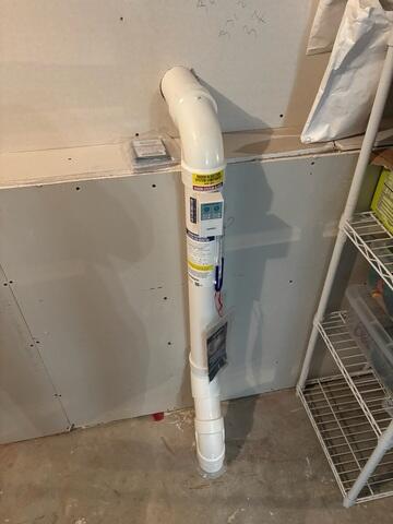 Jackson installed the PVC pipe beneath the footing and connects to the fan installed outside of the home