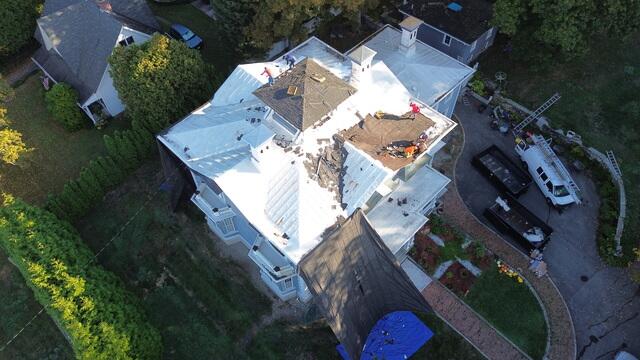 Once the project started, our crew carefully began removing the existing roofing material. With a historic home like Wayne's, precision is key. The crew worked to protect the structure while taking off each section of the old roof. This step exposed the condition of the underlying decking and highlighted just how much water infiltration had occurred over the years.
