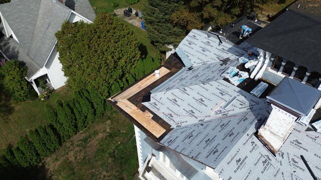 With the underlayment secured, our team began installing the .060 Black EPDM Membrane along the edges of the flat roof. Using the fully adhered system, each piece was bonded with adhesive. Seam tape was applied along all perimeters and seams to ensure a tight, weatherproof seal. This was the first step in rebuilding the flat roof sections.
