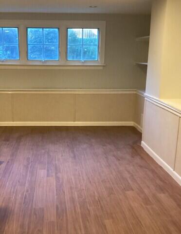 This image shows the completed project with our Elite Plank Flooring in the color "Walnut" and our EverLast Wall Restoration system!
