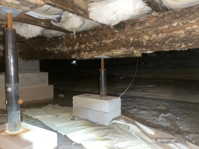 This photo, also taken upon the initial inspection, shows the rusted lally support column. The high moisture content in this space wasn't just ruining the wood, it was also torturing everything else, (the plumbing, the ducts, the fiberglass, even the concrete walls).