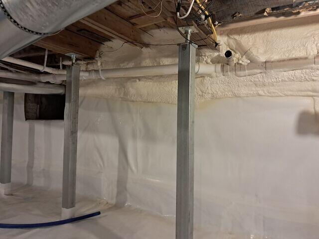 CleanSpace® Encapsulation System: A durable, 20-mil reinforced vapor barrier was installed across the entire floor and walls, sealing out ground moisture and humidity. The bright white liner instantly improved the space's appearance and usability.

Closed-Cell Spray Foam Insulation: Applied to crawl space walls, the foam provides insulation and an additional moisture barrier, helping regulate temperature and reduce energy loss.

SmartJack® Support System: Galvanized steel SmartJacks were installed to reinforce and stabilize the sagging floor system above. Each jack is fully adjustable, providing long-term structural support and preventing future settling.