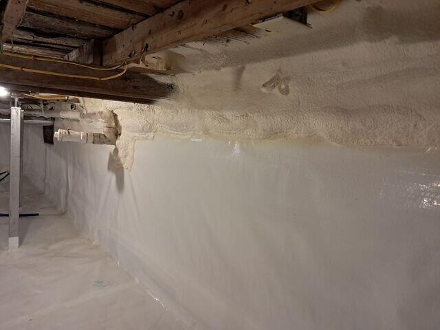 CleanSpace® Encapsulation System: A durable, 20-mil reinforced vapor barrier was installed across the entire floor and walls, sealing out ground moisture and humidity. The bright white liner instantly improved the space's appearance and usability.

Closed-Cell Spray Foam Insulation: Applied to crawl space walls, the foam provides insulation and an additional moisture barrier, helping regulate temperature and reduce energy loss.