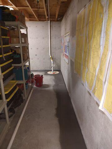 WaterGuard® Interior Drainage System: Installed along the interior perimeter of the basement floor, WaterGuard captures groundwater seepage from the walls and floor joint, directing it safely to the sump pump. Its clog-resistant design ensures long-term reliability.

TrenchDrain™ System: To address surface water entering through the bulkhead area, a TrenchDrain was installed and connected directly to the WaterGuard system. This ensures that any water entering near doorways or entry points is immediately collected and diverted.

TripleSafe® Sump Pump System: The heart of the waterproofing solution, the TripleSafe provides three levels of protection - a primary pump, a secondary pump for heavy flow, and a battery backup pump for peace of mind during power outages.