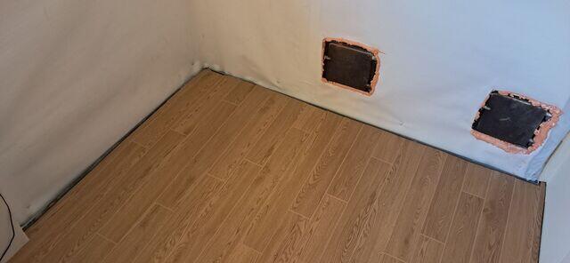 ThermalDry® Elite Plank Flooring System: Once the basement was fully waterproofed, the team installed Basement Systems' exclusive Elite Plank flooring - a durable, waterproof, and attractive wood-look plank designed specifically for finished basements. Unlike traditional flooring, it will never warp, buckle, or support mold growth, even in high humidity. CleanSpace® Wall System: A bright, durable vapor barrier was applied to the foundation walls. It prevents moisture from evaporating into the space and directs any wall seepage down into the WaterGuard system.