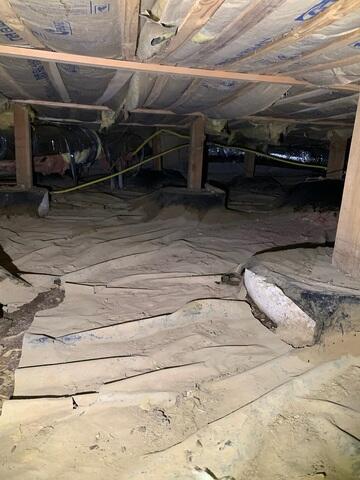 The vapor barrier around the footing of the wooden posts was ripped and caused water to enter. There was rodent droppings and urine all over the old barrier causing the home to smell.