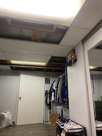 The original drop ceiling was aged and damaged, with several cracked and missing tiles throughout the basement. The ceiling grid showed wear, and the space felt dark and unfinished - in need of an update to restore a clean, cohesive look.