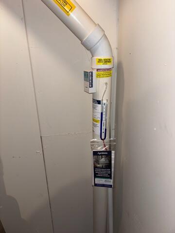 The PVC pipe that connects to the footing of the home and to the fan