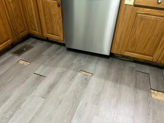 This photo shows what the kitchen floor looked like upon the initial inspection. Not only was it unsightly, but the homeowners were also dealing with sticky cabinets.