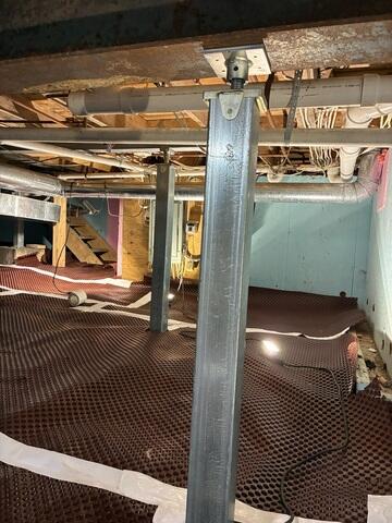 SmartJack™ Support Posts were installed on engineered footings to lift and support sagging beams and joists, correcting floor unevenness and preventing future settlement.

CleanSpace® Vapor Barrier System was mechanically fastened and sealed to encapsulate the crawl space, providing a durable moisture barrier and clean, bright surface.