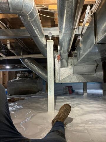 SmartJack™ Support Posts were installed on engineered footings to lift and support sagging beams and joists, correcting floor unevenness and preventing future settlement.

CleanSpace® Vapor Barrier System was mechanically fastened and sealed to encapsulate the crawl space, providing a durable moisture barrier and clean, bright surface.
