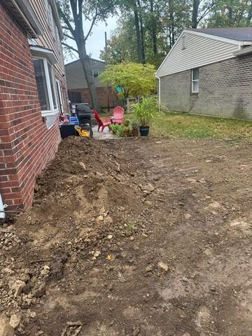 This photo was taken upon completion. We backfilled the piers with soil to conceal them completely after the home was lifted back up.