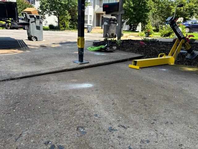 Unlevel driveway panel that sunk do to voids in the soil.