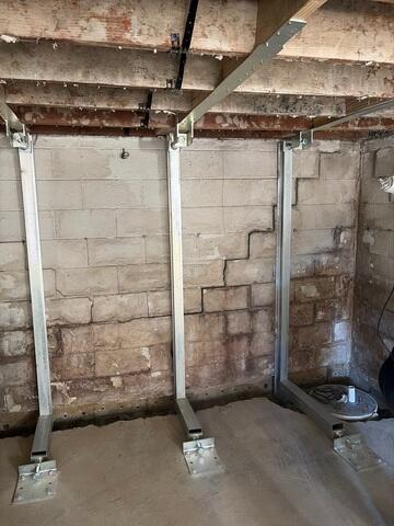 This is what the wall looked like once we had set the three PowerBraces in place, but had not yet tightened them to straighten the wall out. You can see how the top right corner of the wall had a stair-step pattern crack spanning down towards the middle of the wall.