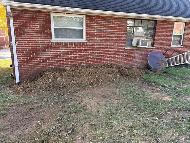 This shows the opposite side of the wall from the outside. We had to excavate the soil down along this wall in order to straighten it out. We also applied a TVB (topsite vapor barrier) to the wall from the outside to stop moisture from further degrading the concrete blocks. This was after we backfilled the hole and the project was complete.