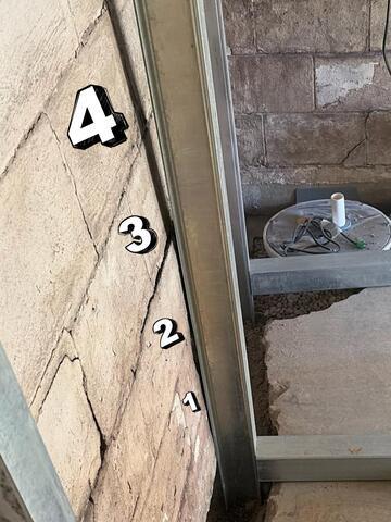 This photo shows a closer view before the straightening. We've numbered out the rows of blocks from the floor up so you can compare to the next photo, which was taken from the same angle. Look closely at the space between the shadow to the right of block number four and the brace - before heading to the next photo.