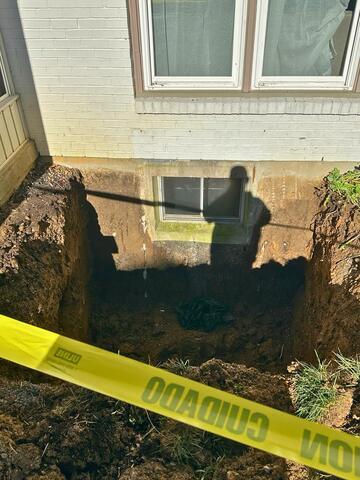 This was what the existing window looked like. You can see we have already dug the hole. When digging the hole, we made sure to carefully excavate around the foundation, making sure to not disrupt the homeowners existing exterior drainage system.