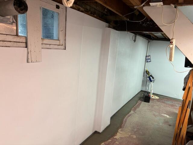 WaterGuard drainage system sealed with fresh concrete along the perimeter, BrightWall panels installed for a clean, bright finish.