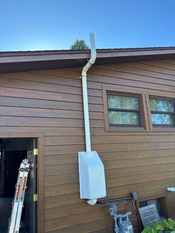 After: Jackson successfully secured the Radon Mitigation System outside the home.
