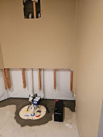 TripleSafe sump pump system installed and concreted in place, providing triple-layer protection during heavy rains and power outages.