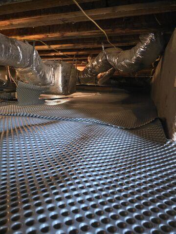 Drainage Matting was placed across the crawl space floor to create a channel for groundwater to flow efficiently toward the drainage system.