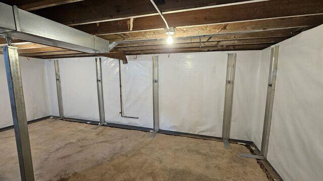 This image highlights a fully repaired basement wall using a combination of GeoLock™ Channel Anchors and CleanSpace® encapsulation. Multiple anchors are secured from floor to joists, offering durable structural reinforcement. The CleanSpace® liner wraps the wall for moisture protection and improved appearance, ensuring the basement remains dry and ready for future finishing.