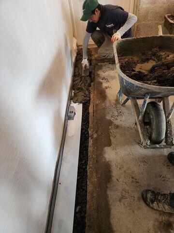 Fresh concrete poured over WaterGuard, completing the basement waterproofing system.