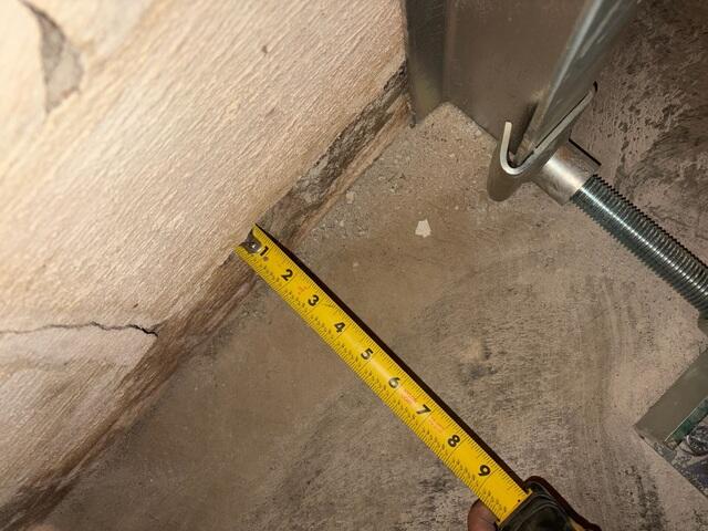 This photo shows that we were able to slide the wall completely back onto the footing. This picture was taken from the same angle as the last photo, but was taken after the straightening.