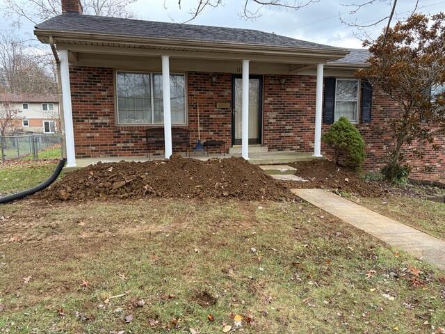 This was what the yard looked like after we backfilled the hole. The troubled wall was actually underneath the porch slab.