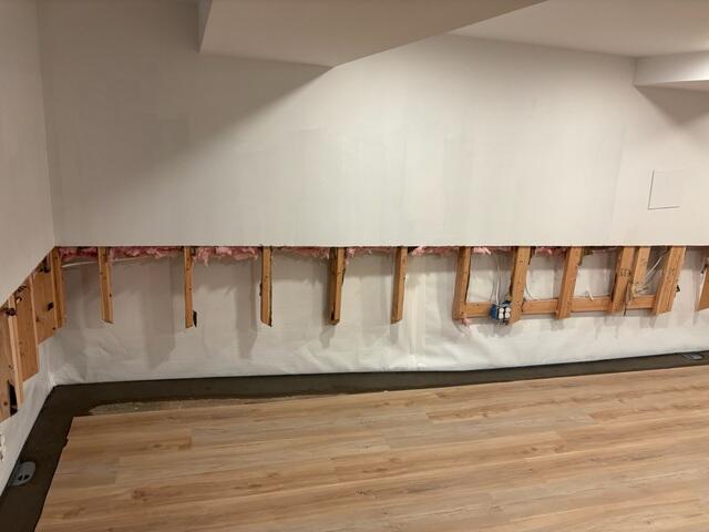 We installed our WaterGuard Drainage System to efficiently collect any remaining wall seepage and floor water. This system works seamlessly with our CleanSpace Wall Panels, which act as a bright, durable moisture barrier that directs wall water down into the WaterGuard, transforming the look of the basement while ensuring all moisture is contained and managed.