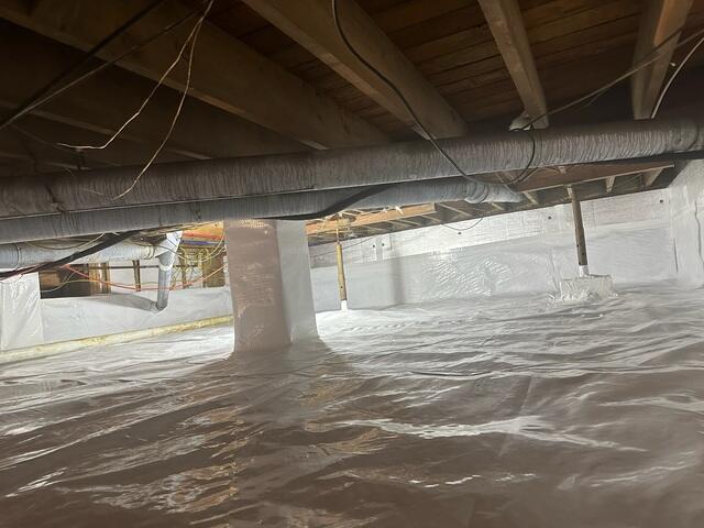 The CleanSpace Vapor Barrier System was installed to completely seal the crawl space floor and walls. This thick, inorganic liner isolates the home from ground moisture and humidity, providing a permanent barrier against water vapor seepage.