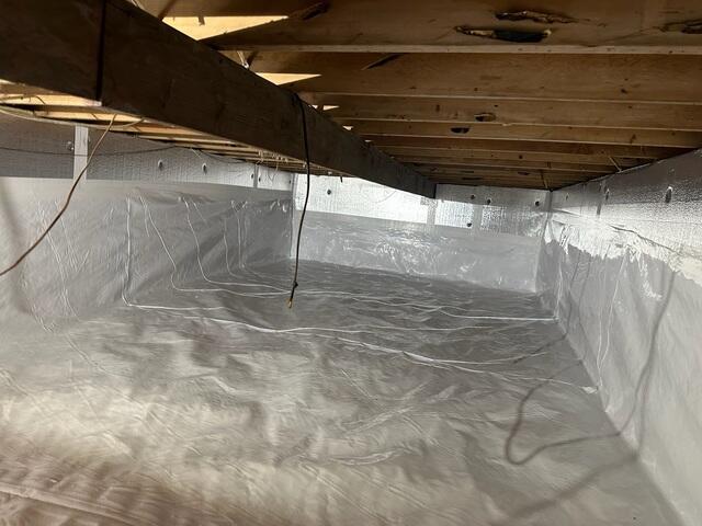 CleanSpace was installed to permanently seal the crawl space. This heavy-duty, reinforced liner covers the floor and walls, effectively isolating the home from ground moisture, soil gases, and external humidity, ensuring a completely dry environment.