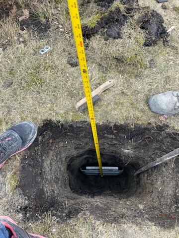 Our crew installing the earth anchor that connects to the interior wall