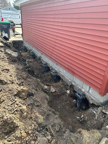 The crew installed Helical Piers and attached the brackets to the footing