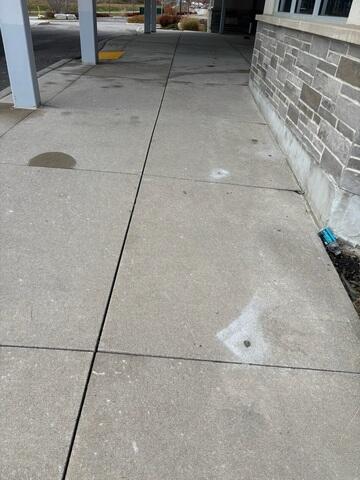 This wider view captures the restored walkway, showing multiple slabs that we successfully lifted and leveled to eliminate trip hazards. The entire area has been prepared for long-term durability with the application of our premium crack and joint sealant along all seams.