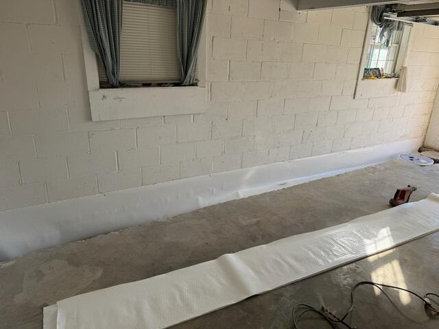 Step 2: We then covered the weeping holes with our Wall-E system, (not to be confused with the movie). This vapor barrier will make sure that the weeping holes drain right into the trench.