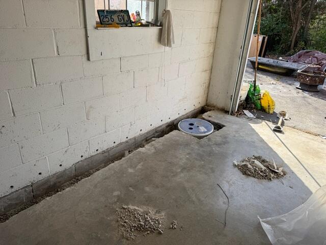 Step 1: We excavated the basement floor slab around the perimeter of the problematic area to make room for our drains. We then drilled weeping holes through the blocks to invite built up water into our system. Cylinder blocks are hollow, and oftentimes, they hold a lot of water inside of them. Because of this, we made sure every block received a proper weeping hole.