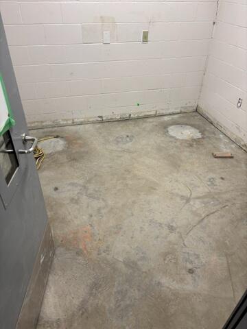 This room shows additional areas of slab movement, where voids beneath the concrete were beginning to impact floor stability.