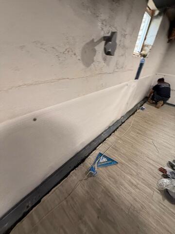 WaterGuard was installed around the perimeter of the basement to direct any seepage to the sump pump for removal.