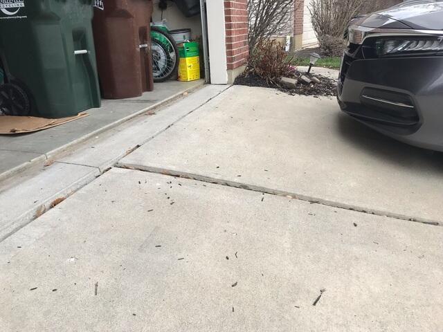 This photo was taken upon the initial inspection and shows the two settled slabs attached to the garage opening. These two sunken slabs could have caused someone to trip.