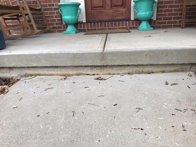 This photo was taken upon the initial inspection and shows just how far the sidewalk had settled into the ground. When the sidewalk was first poured, it left no room between the porch slab and the top of the sidewalk.You can see that there was about a two to three inch gap before we raised it back up.