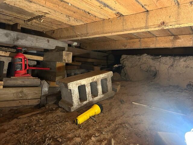 Before: Our Design Specialist, Jason, noted the crawl space was not properly supported, leading to the sagging floors.